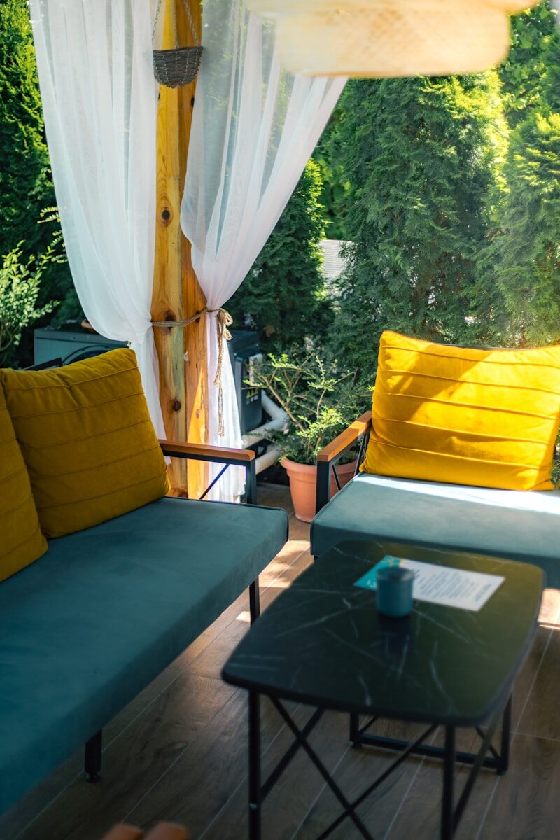 a couple of couches sitting on top of a wooden floor