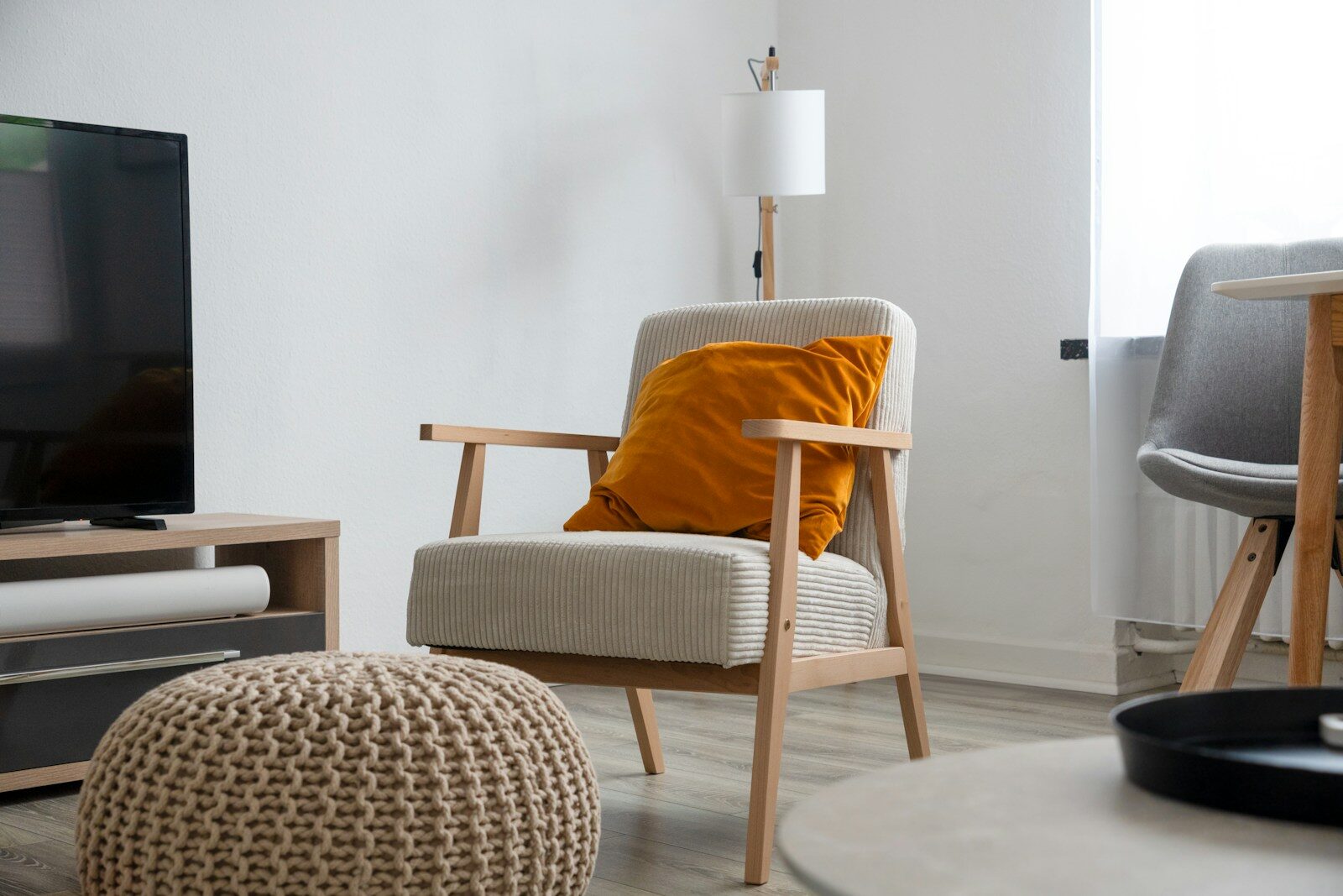 a living room with a couch, chair and television